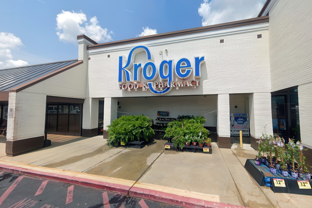 The exterior of a Kroger store features a vibrant sign, showcasing the grocery and pharmacy services.