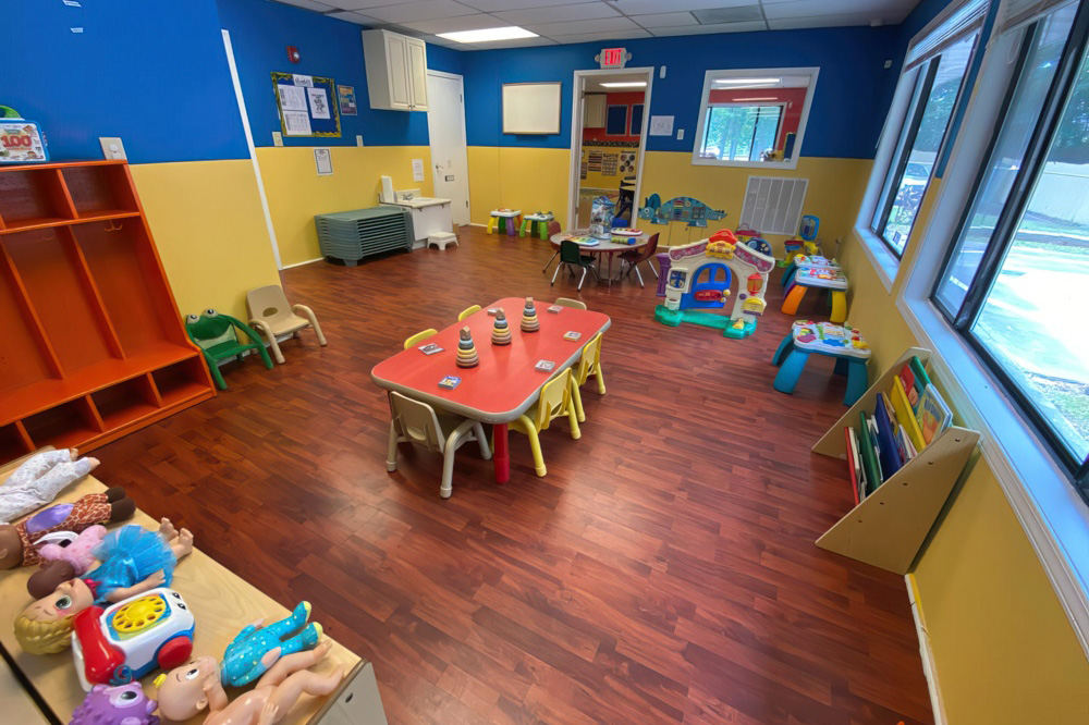 A colorful, well-organized classroom filled with toys and learning materials, creating a welcoming space for children.